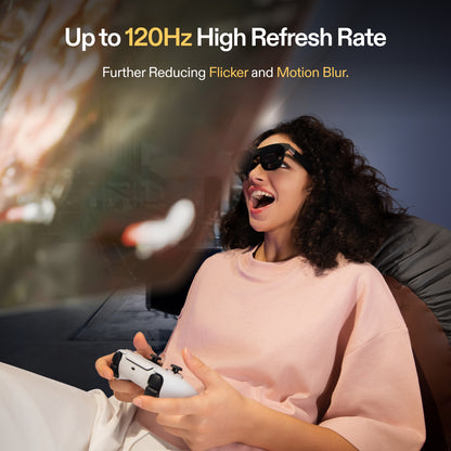 Woman wearing XREAL One AR glasses playing video games, illustrating up to 120Hz refresh rate that reduces flicker and motion blur