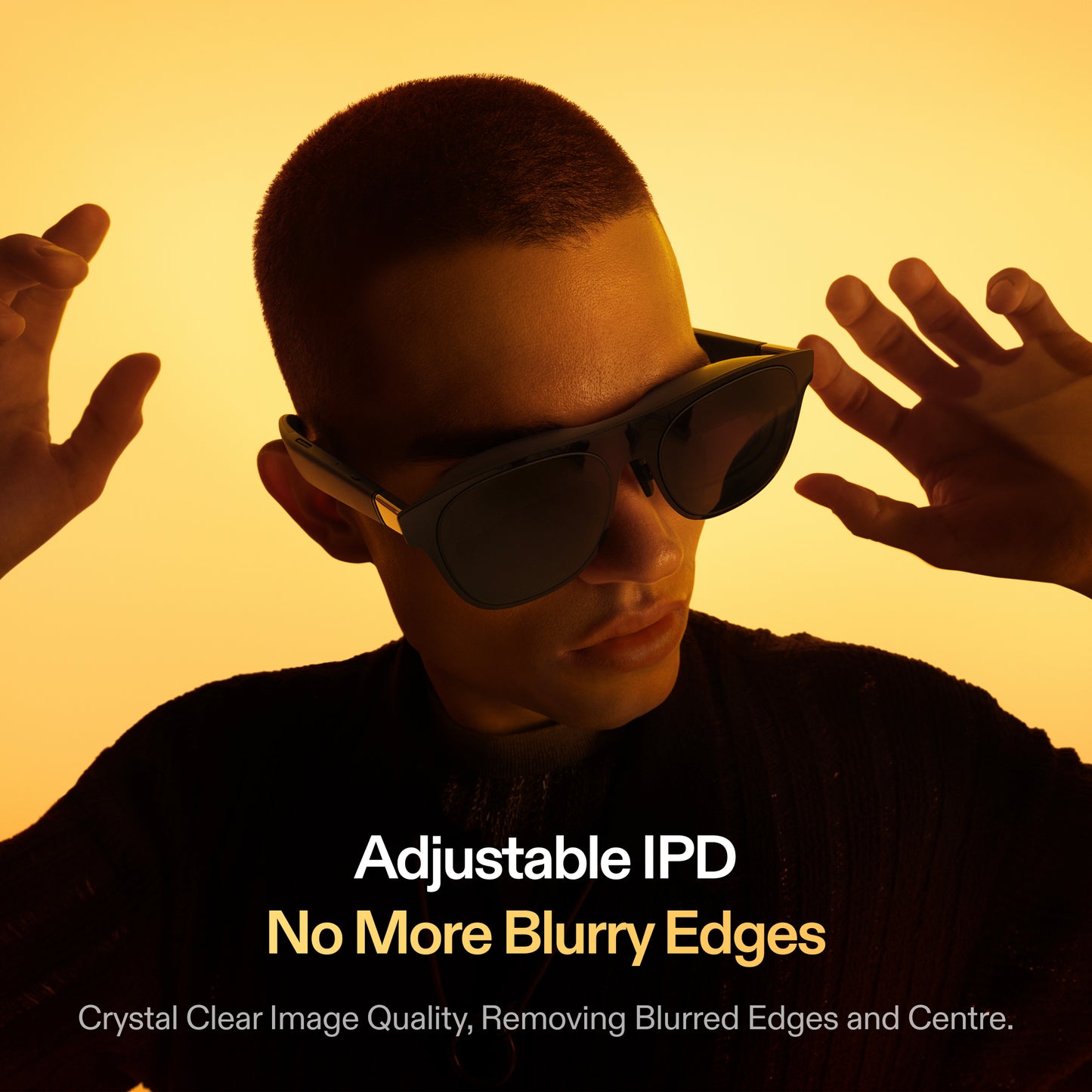 Man wearing XREAL One AR glasses adjusting the frame, illustrating adjustable IPD for crystal clear image quality without blurred edges